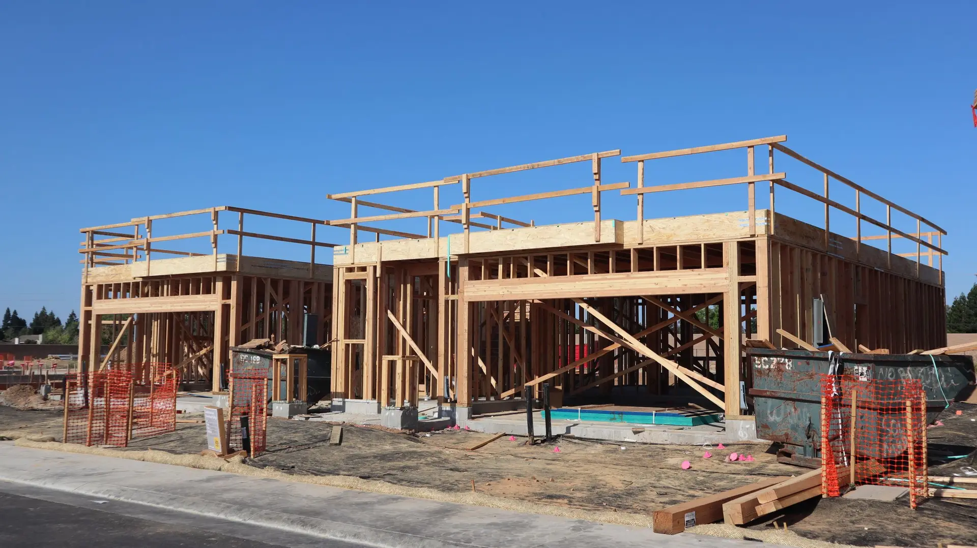 Wood framing and scaffolding on a new house going up on a cleared lot